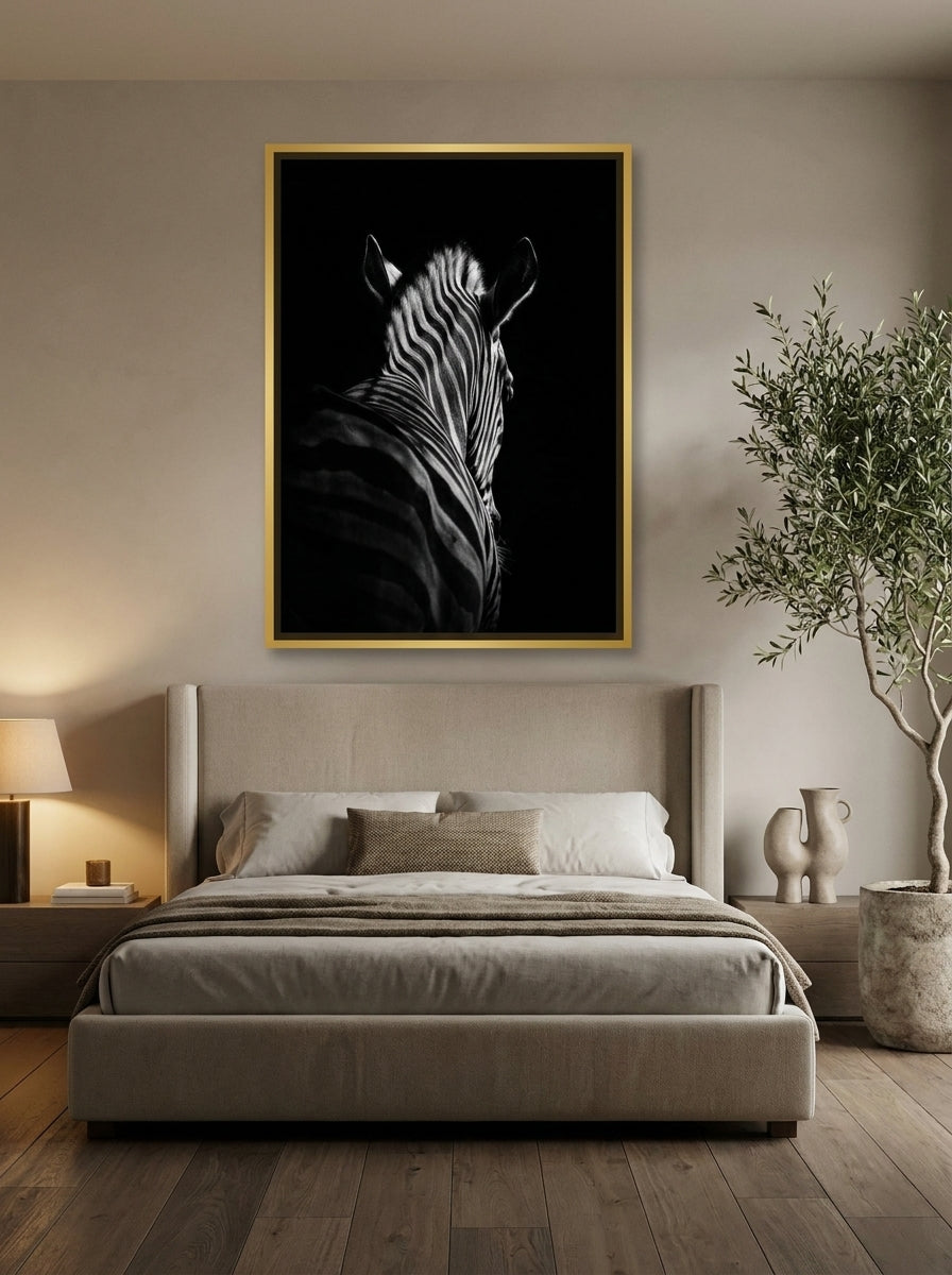 Oversized statement canvas wall art with a gold leaf surround styled on the wall in a luxe bedroom