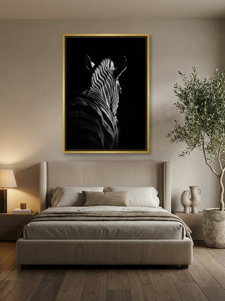 Oversized statement canvas wall art with a gold leaf surround styled on the wall in a luxe bedroom