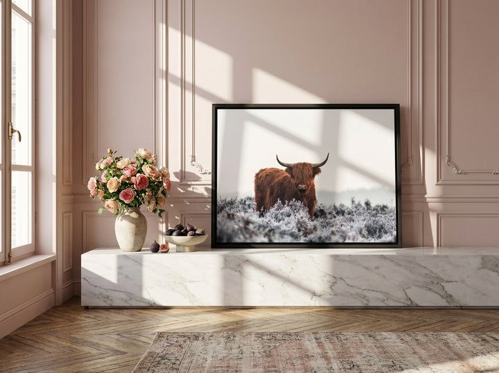 Canvas wall art with a black surround standing on a console in a Parisian living room