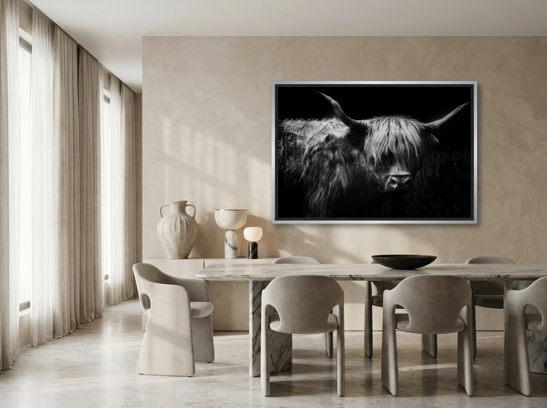 Oversized statement canvas wall art with a silver leaf surround styled on the wall in a luxe dining room