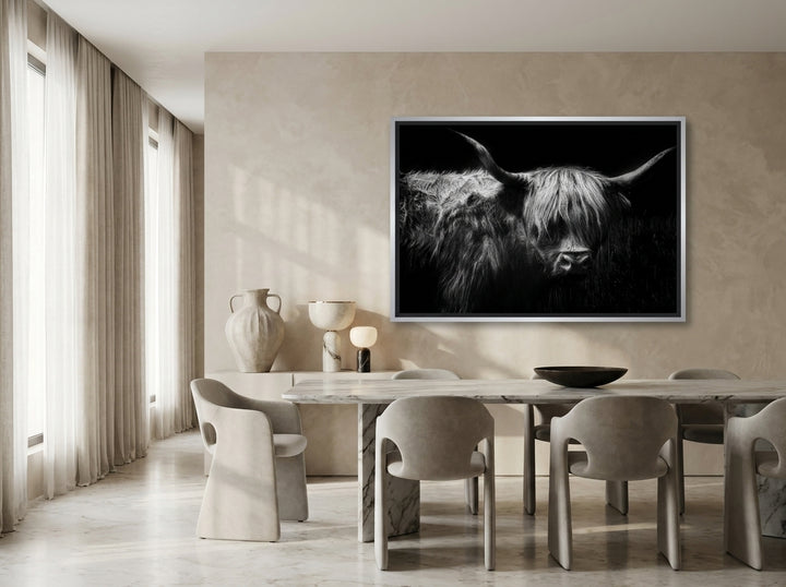 Oversized statement canvas wall art with a silver leaf surround styled on the wall in a luxe dining room