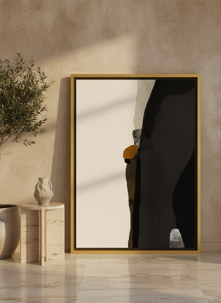 Oversized statement canvas wall art with a gold leaf surround leaning against the wall in a luxe living room