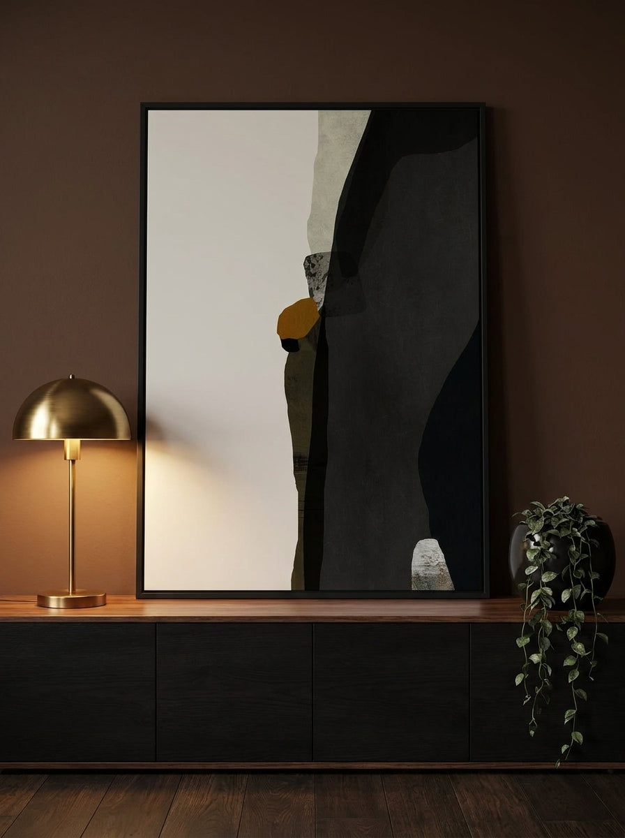 Modern wall art print standing on a console in a moody home office