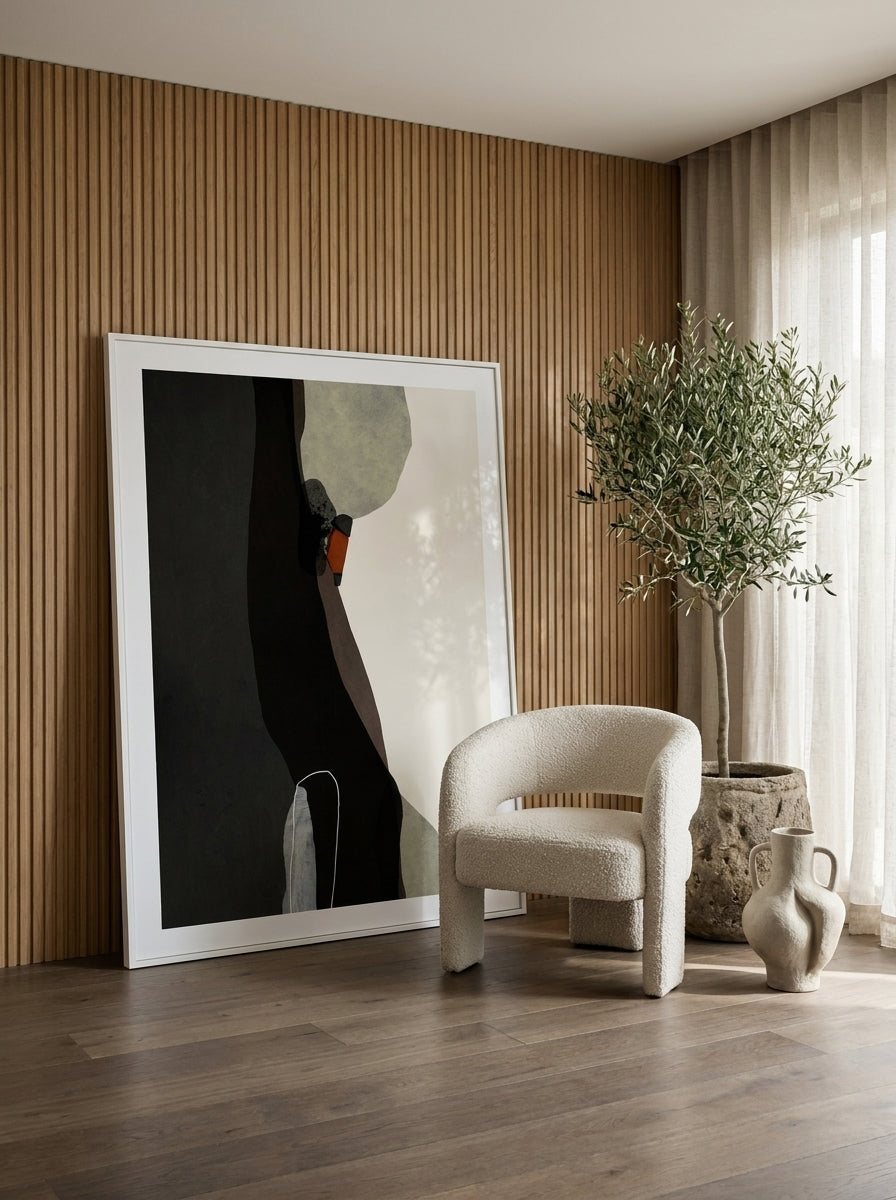Oversized statement modern wall art print leaning against the wall in a luxe living room