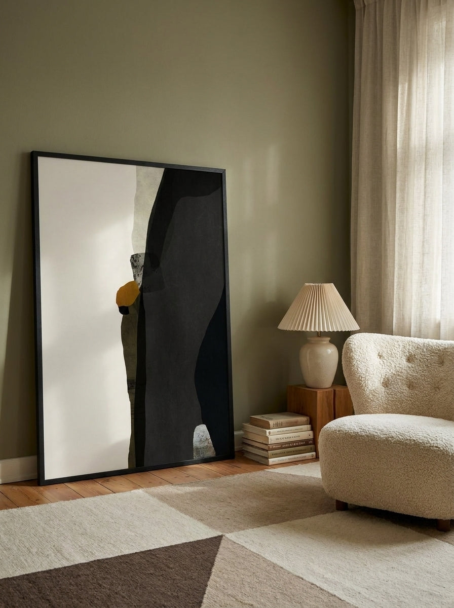 Oversized statement modern wall art print leaning against the wall in a mid-century living room
