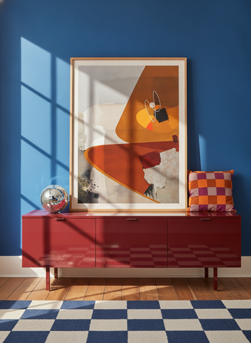 Modern wall art print standing on a sideboard in a colourful eclectic bedroom