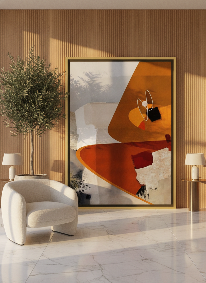 Oversized statement canvas wall art with a gold leaf surround leaning against the wall in a luxe dining room