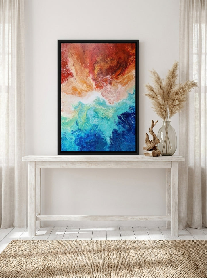 Canvas wall art with a black surround standing on a console in a coastal bedroom