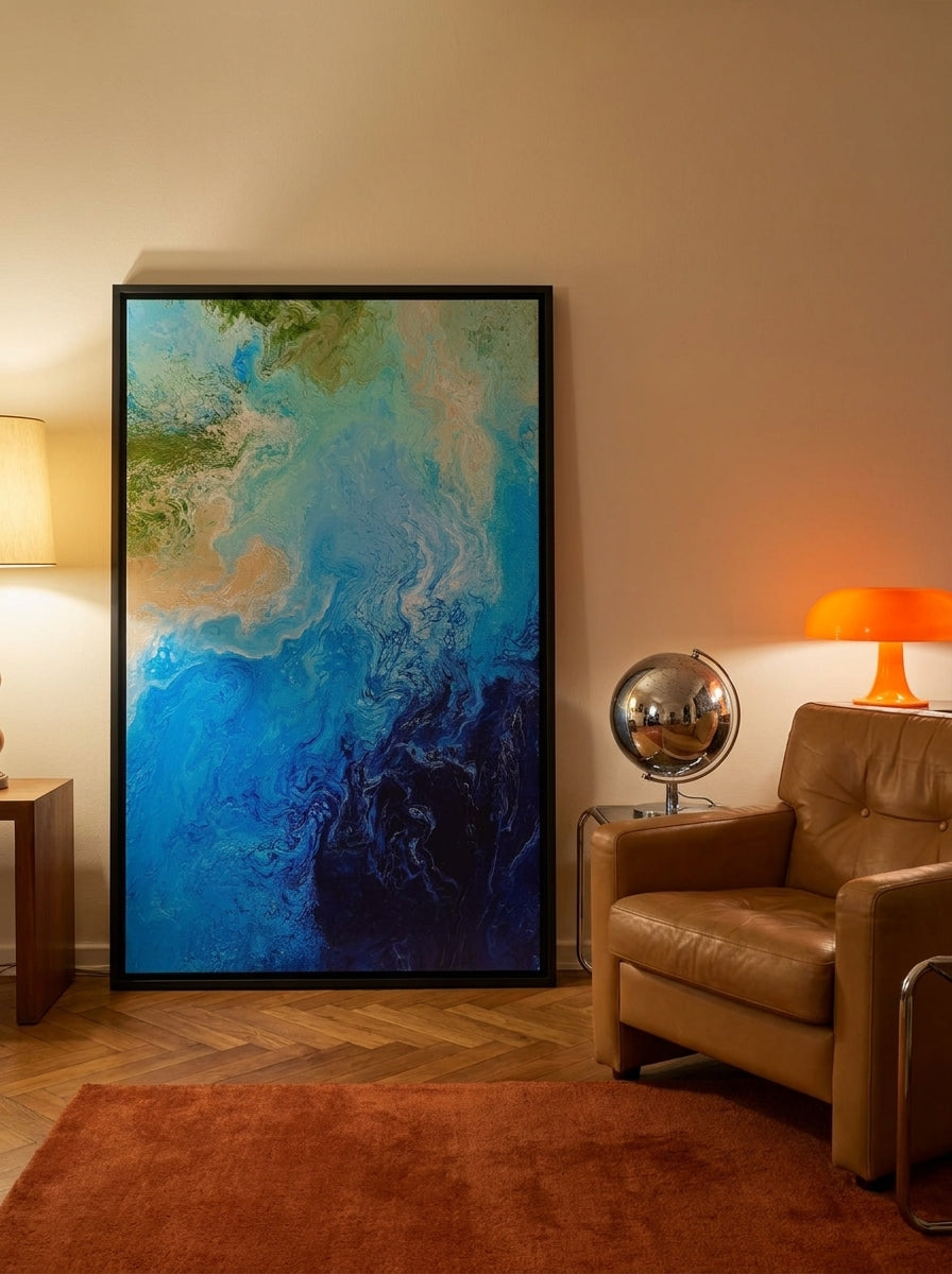 Oversized statement canvas wall art with a black surround leaning against the wall in a retro 70s living room
