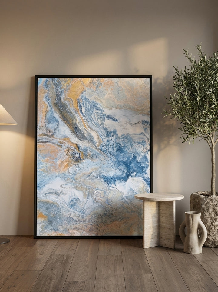 Oversized statement canvas wall art with a black surround leaning against the wall in a luxe living room