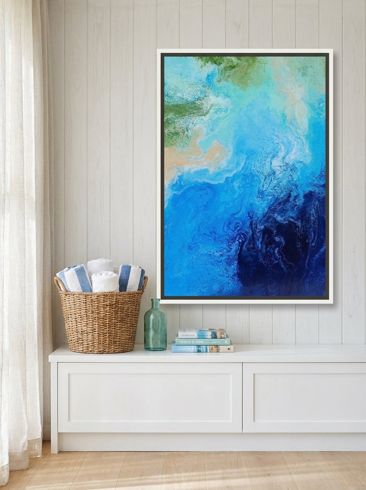 Canvas wall art with a white surround styled on the wall in a coastal bathroom
