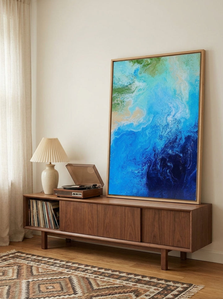 Canvas wall art with a natural timber surround standing on a sideboard in a mid-century home office