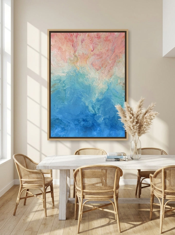 Oversized statement canvas wall art with a natural timber surround styled on the wall in a coastal dining room