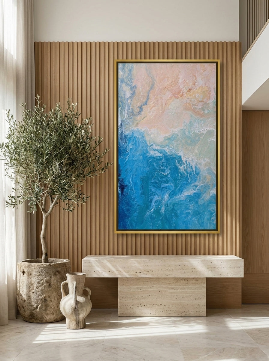 Oversized statement canvas wall art with a gold leaf surround styled on the wall in a luxe living room