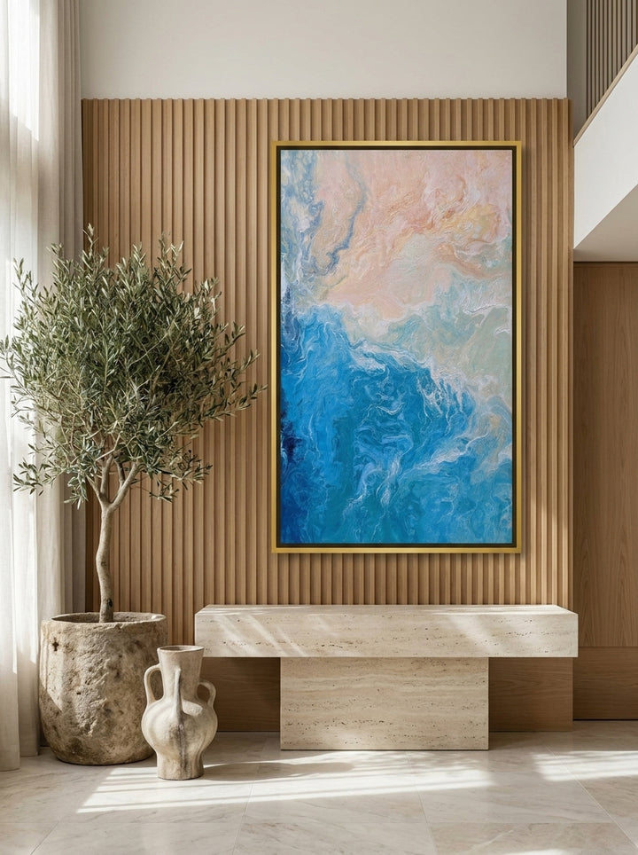 Oversized statement canvas wall art with a gold leaf surround styled on the wall in a luxe living room