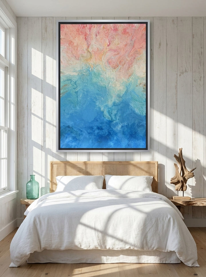 Oversized statement canvas wall art with a silver leaf surround styled on the wall in a coastal bedroom