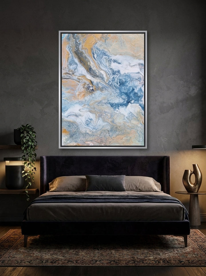 Canvas wall art with a silver leaf surround styled on the wall in a moody bedroom
