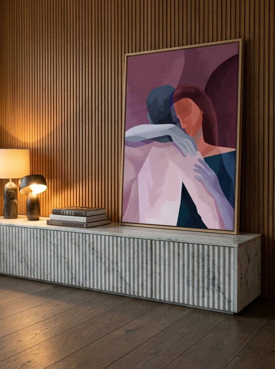 Canvas wall art with a natural timber surround standing on a sideboard in a luxe living room