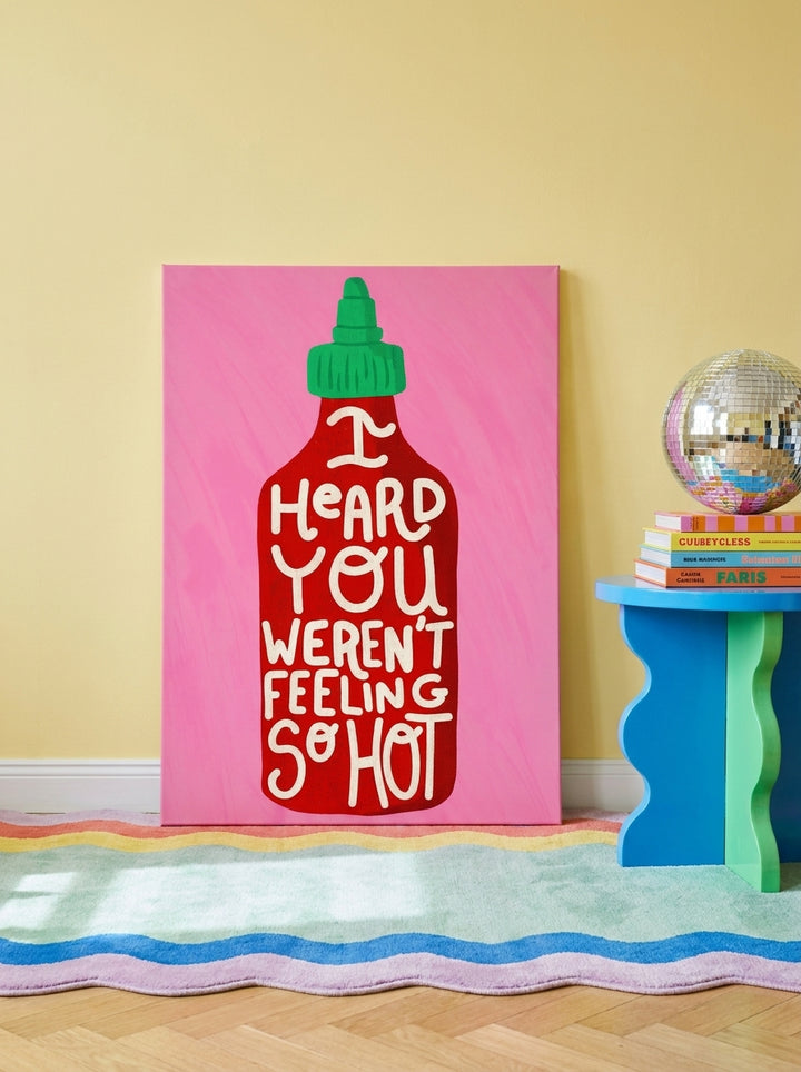 Stretched canvas wall art leaning against the wall in a colourful eclectic dining room