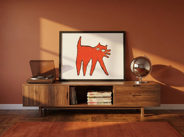 Modern wall art print standing on a sideboard in a retro 70s home office