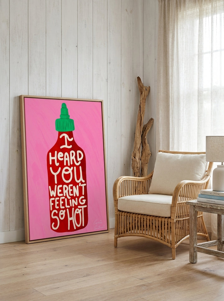Oversized statement canvas wall art with a natural timber surround leaning against the wall in a coastal living room