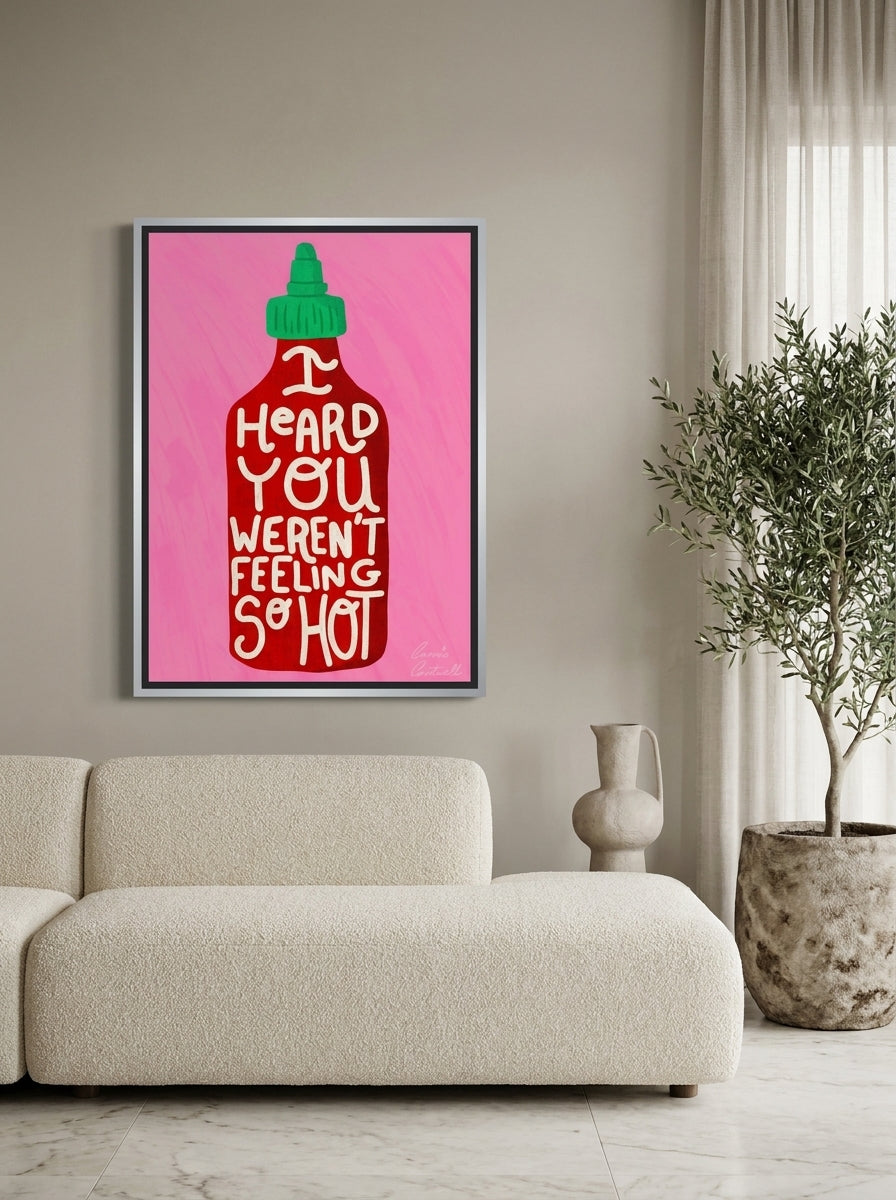 Canvas wall art with a silver leaf surround styled on the wall in a luxe living room
