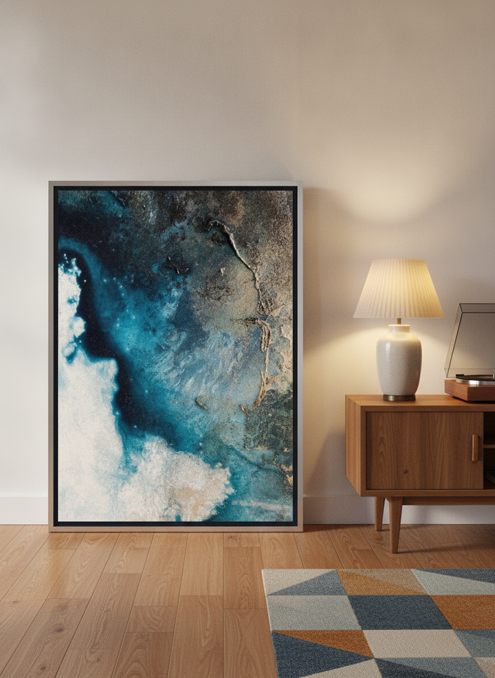 Canvas wall art with a silver leaf surround leaning against the wall in a mid-century home office