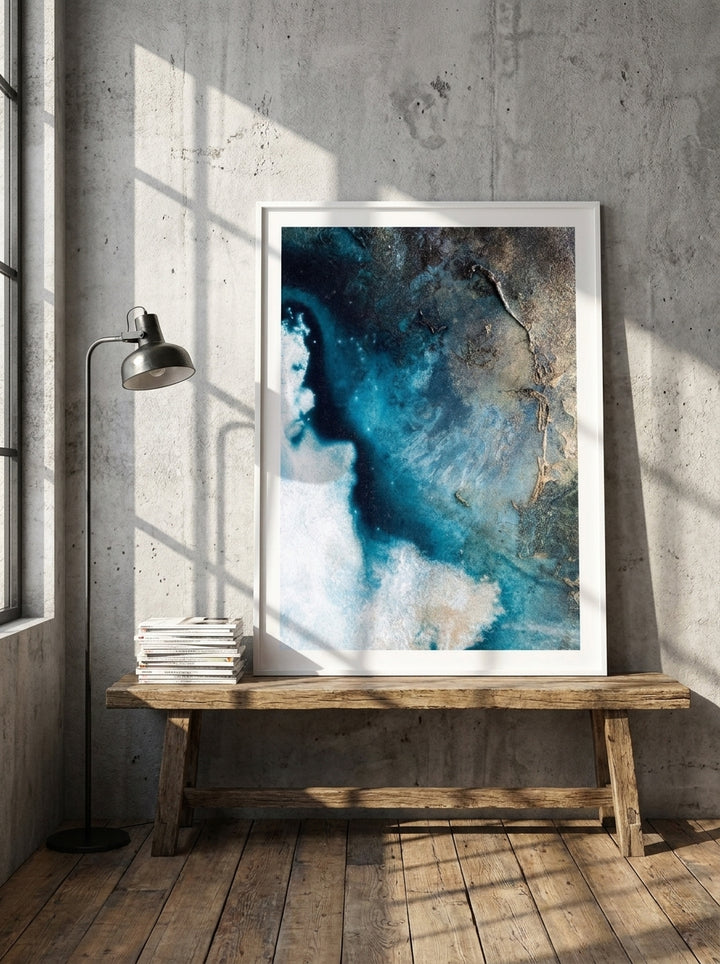 Modern wall art print standing on a bench in an industrial loft bedroom