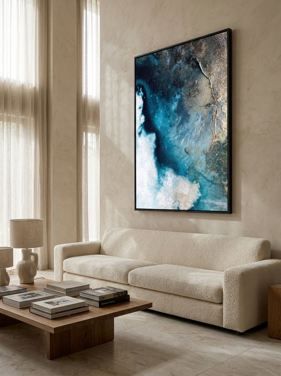 Oversized statement canvas wall art with a black surround styled on the wall in a luxe living room