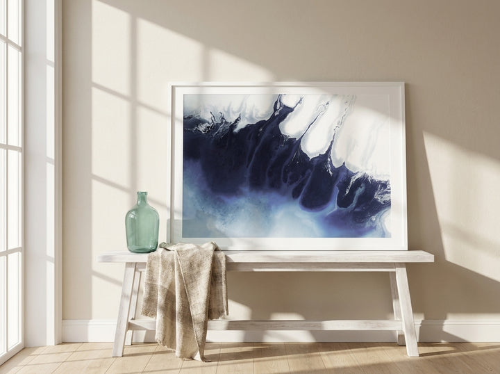 Modern wall art print standing on a console in a coastal home office