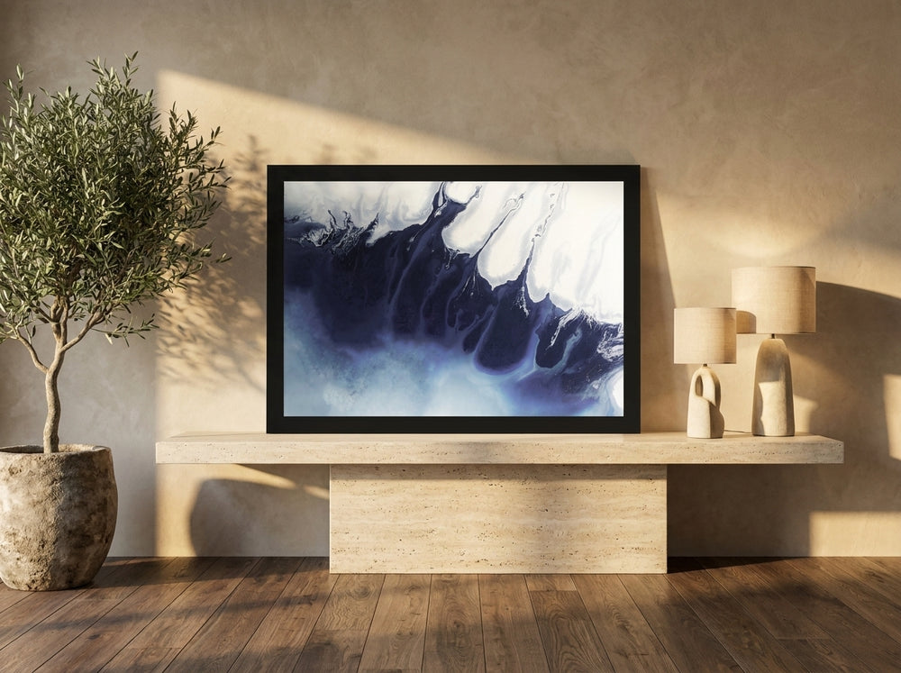 Modern wall art print standing on a console in a luxe bedroom