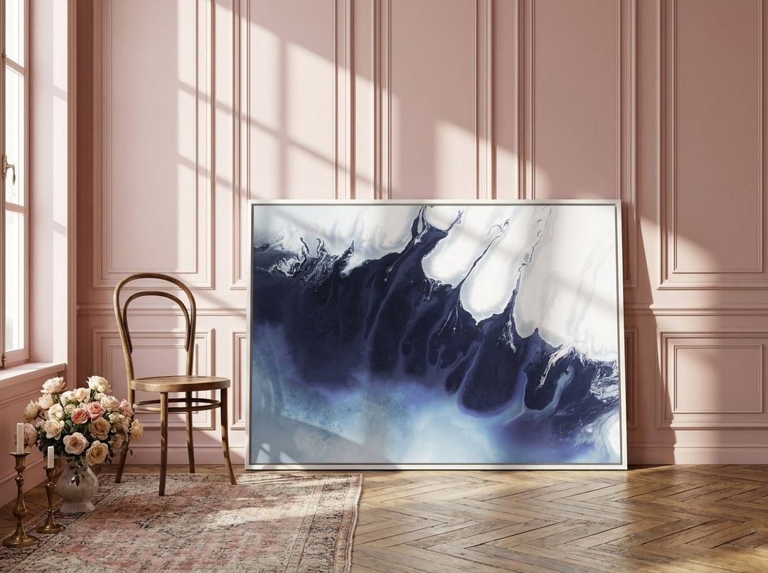 Canvas wall art with a white surround leaning against the wall in a Parisian bathroom
