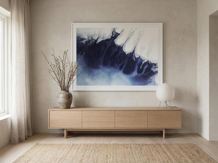 Oversized statement modern wall art print styled on the wall in a warm Japandi living room