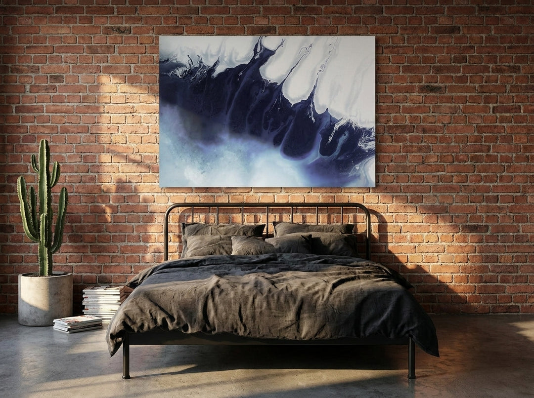Stretched canvas wall art styled on the wall in an industrial loft bedroom
