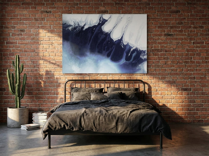 Stretched canvas wall art styled on the wall in an industrial loft bedroom