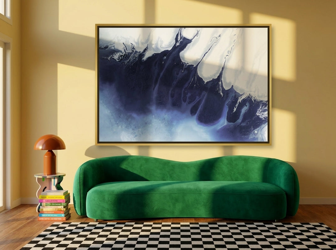 Oversized statement canvas wall art with a gold leaf surround styled on the wall in a colourful eclectic living room