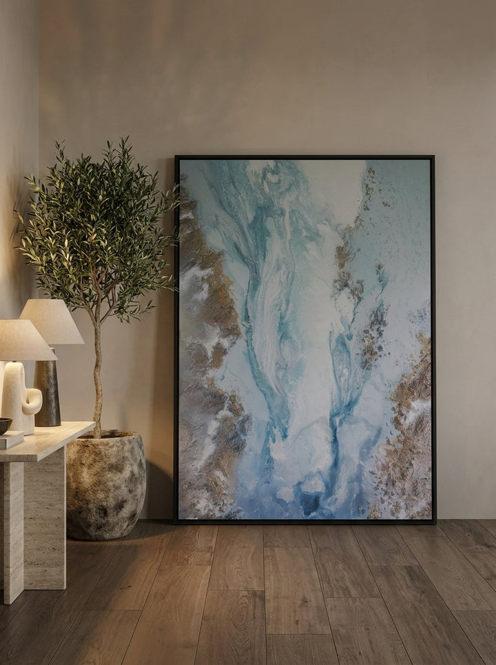 Oversized statement canvas wall art with a black surround leaning against the wall in a luxe dining room