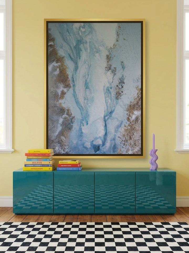 Oversized statement canvas wall art with a gold leaf surround styled on the wall in a colourful eclectic living room