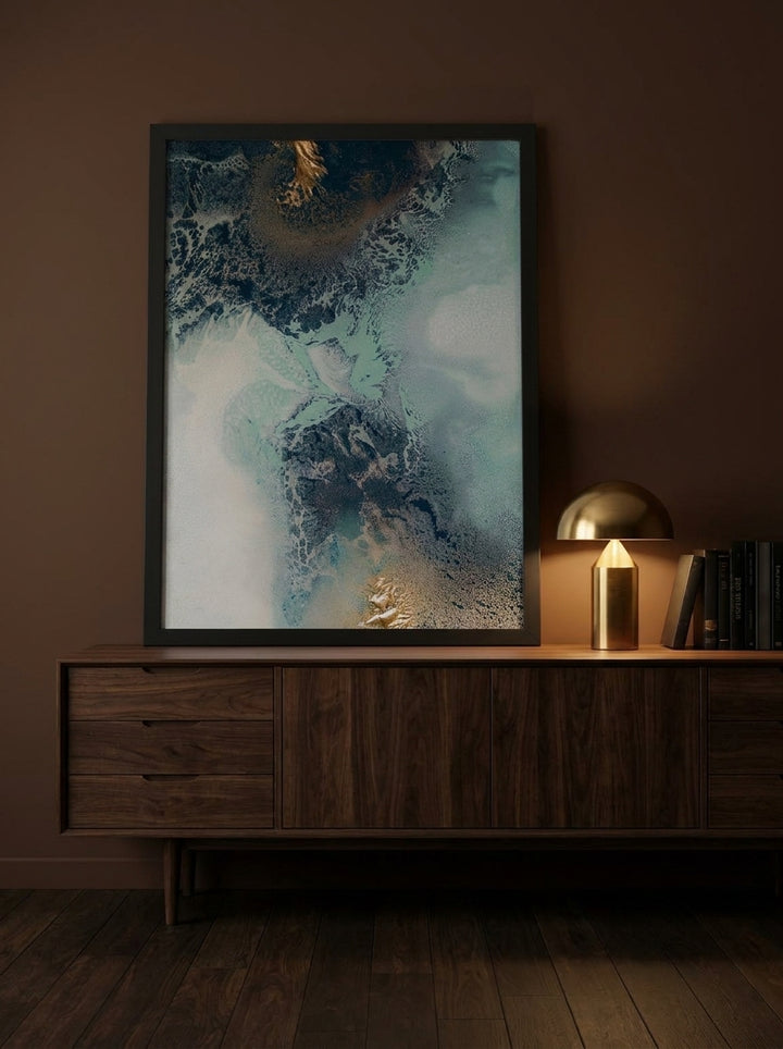 Modern wall art print standing on a sideboard in a moody bedroom