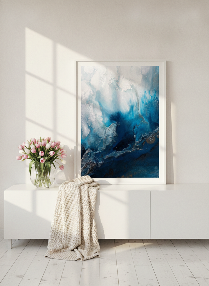 Modern wall art print standing on a sideboard in a bright Scandinavian bedroom