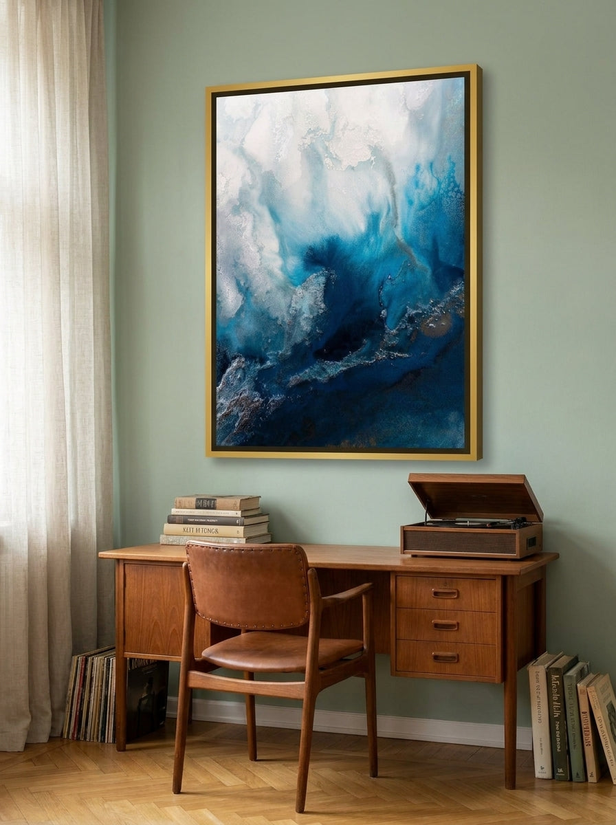 Canvas wall art with a gold leaf surround styled on the wall in a mid-century home office