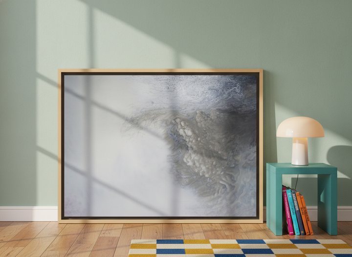 Canvas wall art with a natural timber surround leaning against the wall in a colourful eclectic home office
