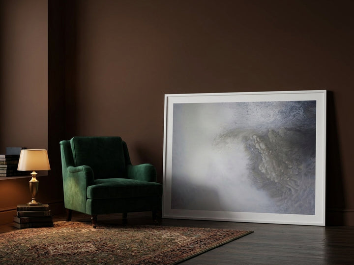 Oversized statement modern wall art print leaning against the wall in a moody living room