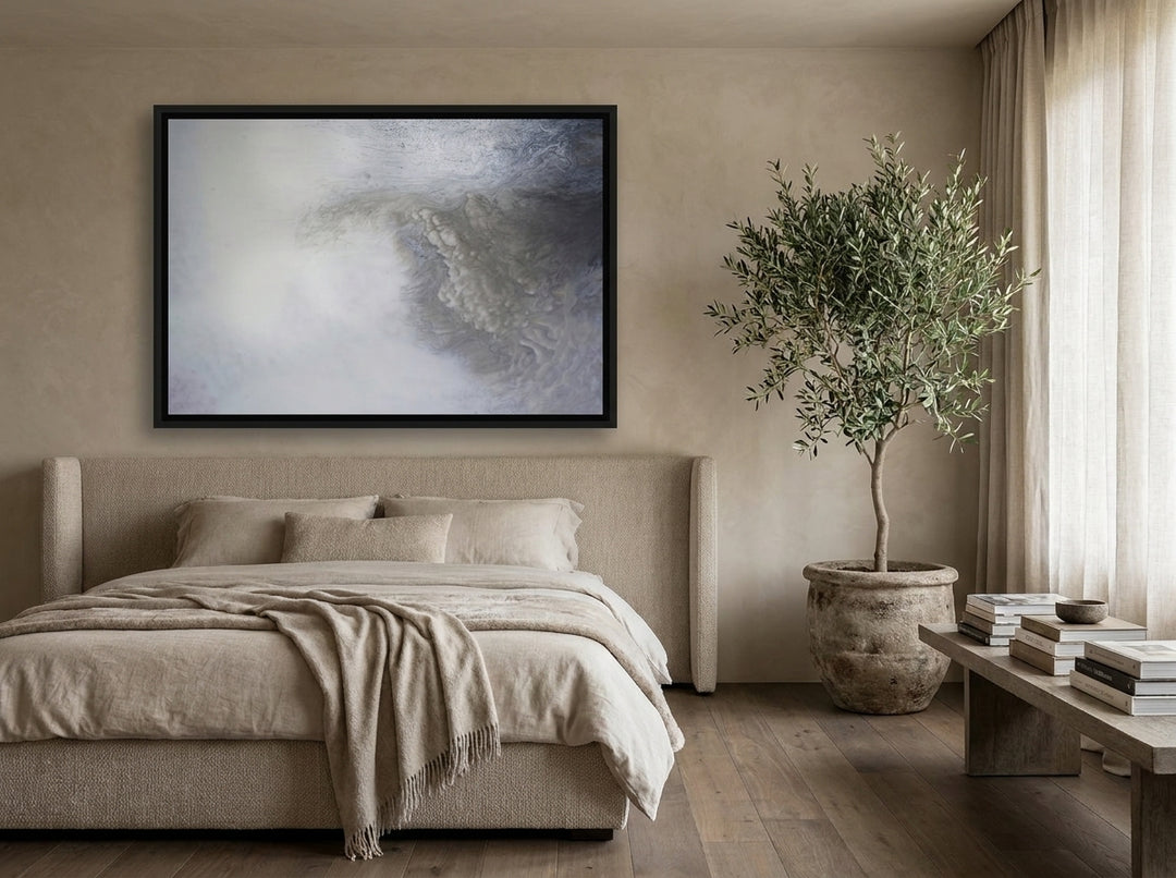 Oversized statement canvas wall art with a black surround styled on the wall in a luxe bedroom