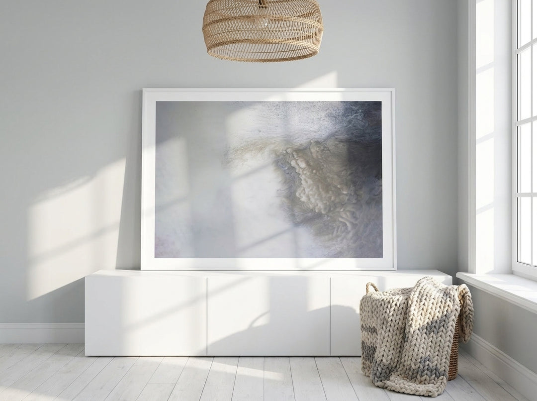 Modern wall art print standing on a sideboard in a bright Scandinavian home office