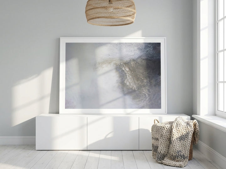 Modern wall art print standing on a sideboard in a bright Scandinavian home office
