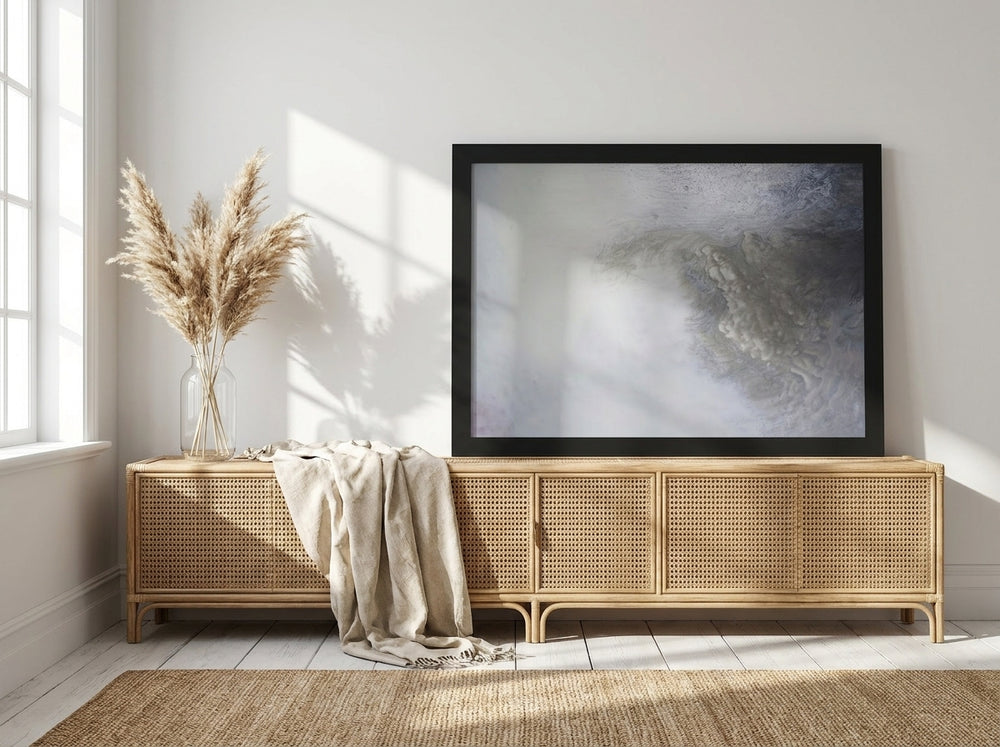 Modern wall art print standing on a sideboard in a coastal bedroom