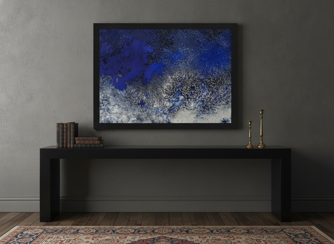 Modern wall art print standing on a console in a moody home office