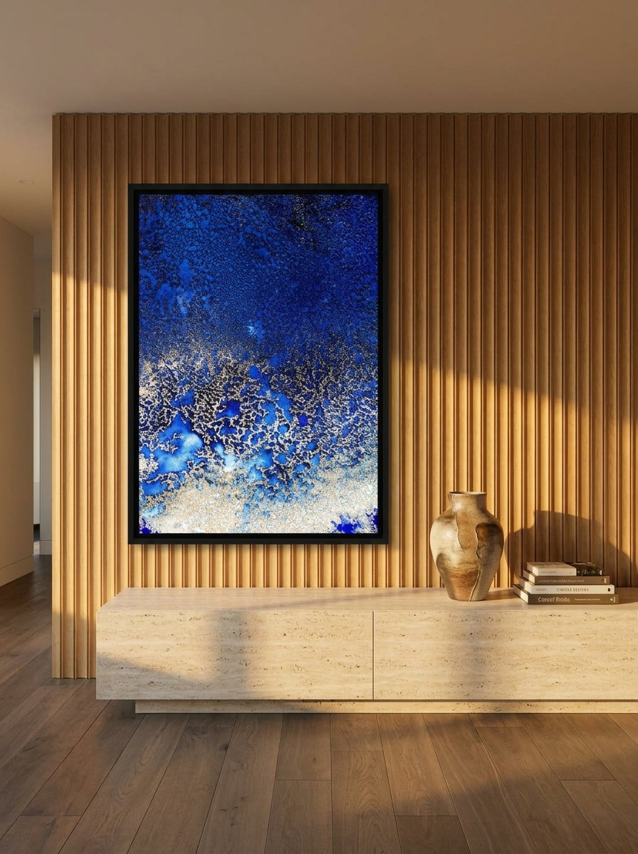 Oversized statement canvas wall art with a black surround styled on the wall in a luxe living room