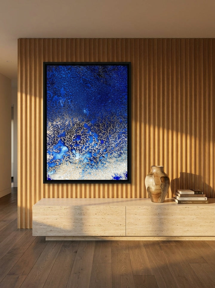 Oversized statement canvas wall art with a black surround styled on the wall in a luxe living room